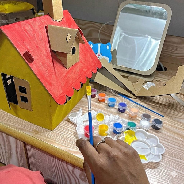 Child using 2pcs DIY Cardboard House Building & Painting Kit: Build, Paint & Play