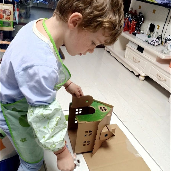 Child using 2pcs DIY Cardboard House Building & Painting Kit: Build, Paint & Play