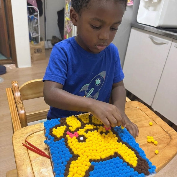 Child using Pompom painting