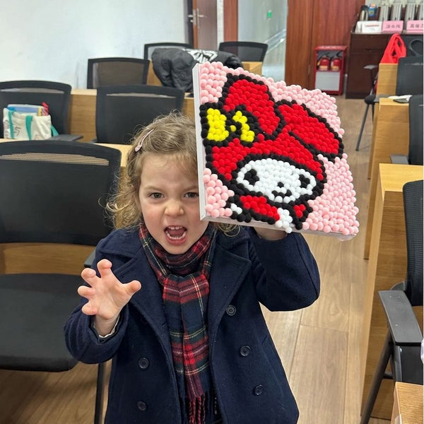 Child using Pompom painting