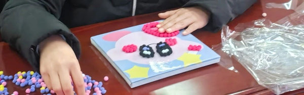 Child using Pompom painting