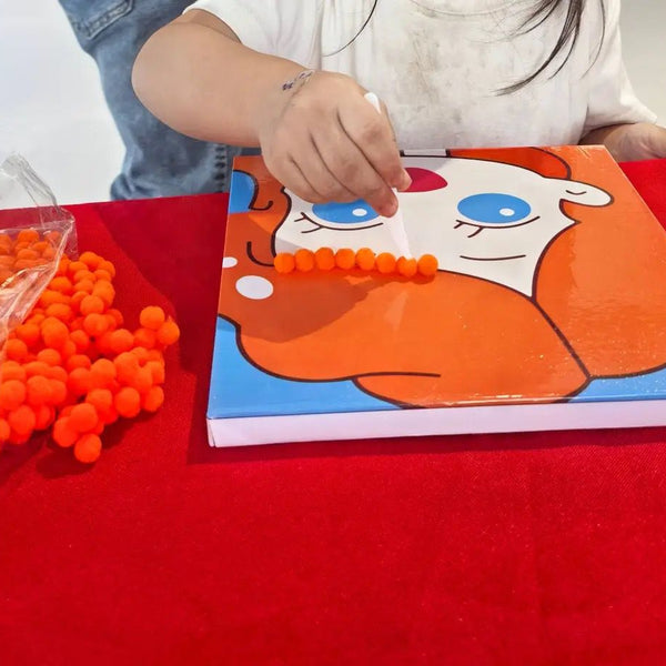Child using Pompom painting