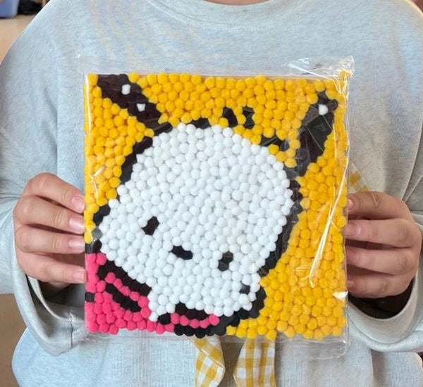 Child using Pompom painting