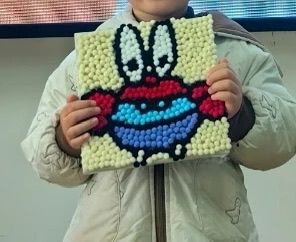 Child using Pompom painting