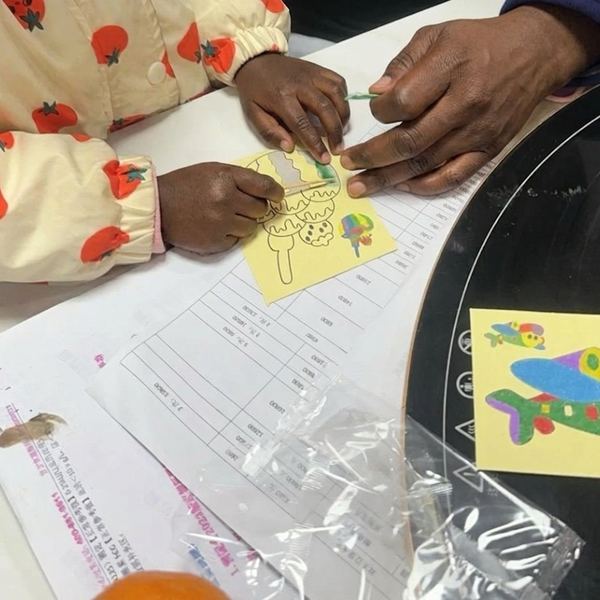 Child using Sand Painting