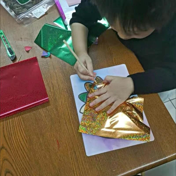 Child using Magic Art Transfer Painting