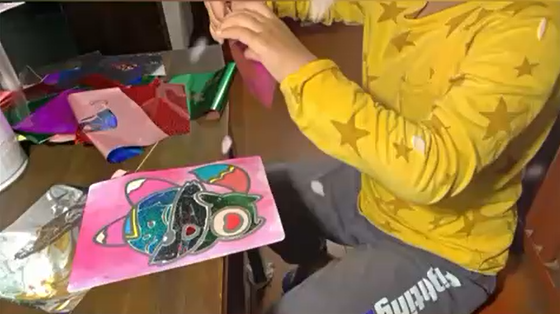 Child using Magic Art Transfer Painting