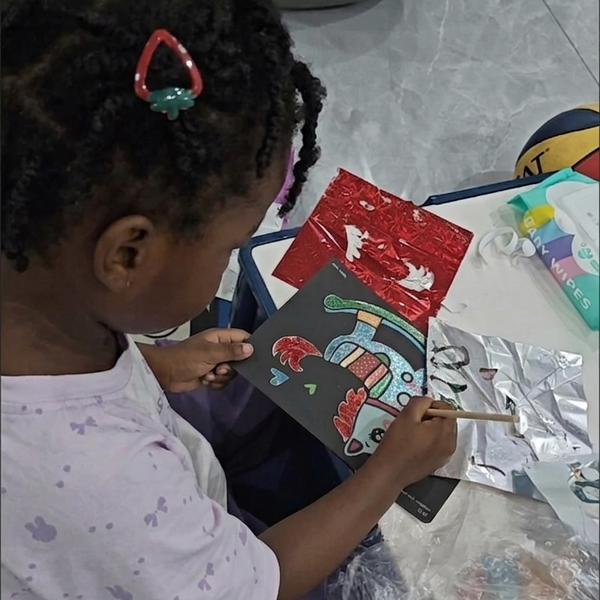 Child using Magic Art Transfer Painting